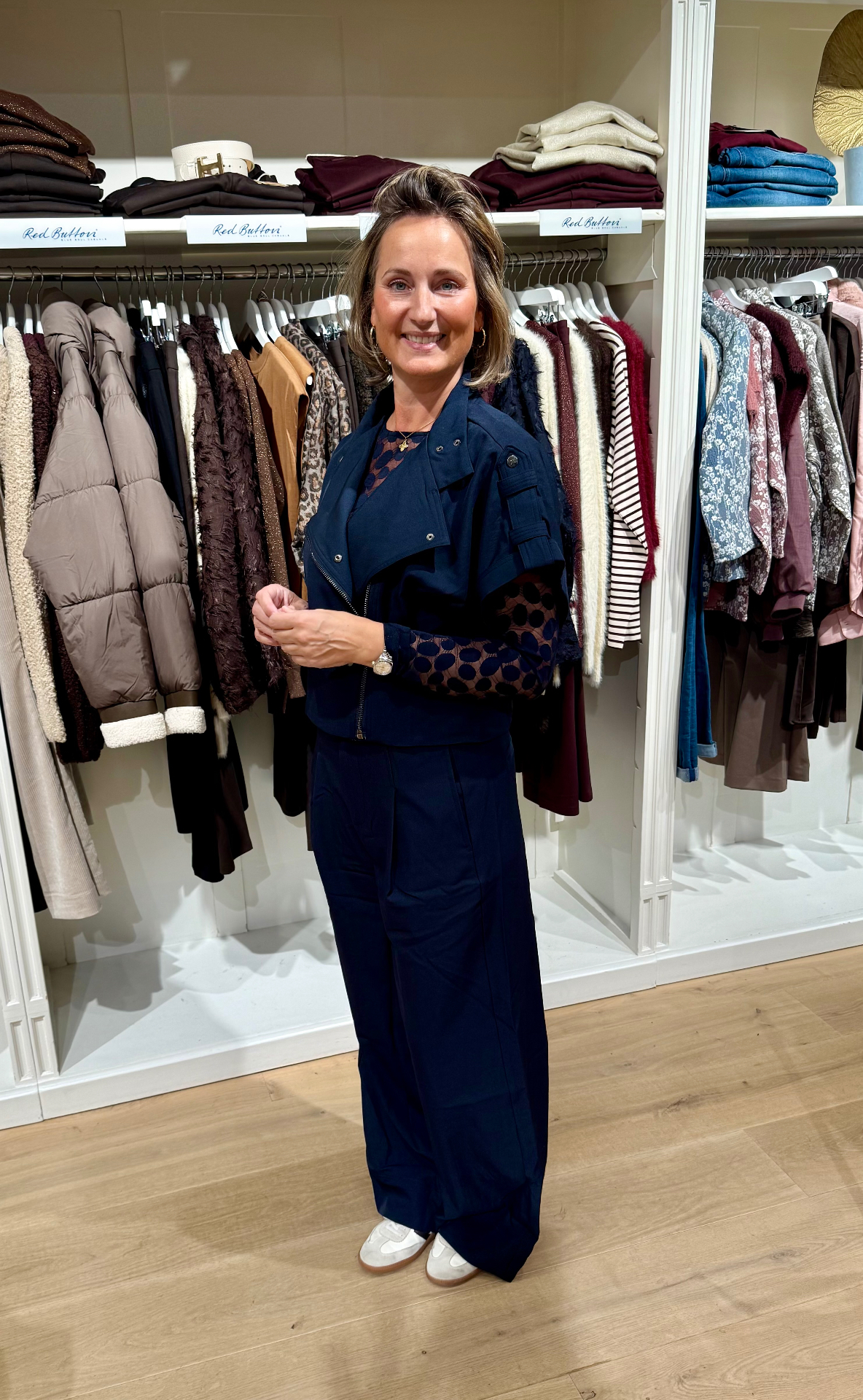 Co Couture outfit in donkerblauw: jasje met ritsen, pantalon met bandplooi en mesh top met stippenprint