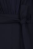 Travel jumpsuit van het merk Studio Anneloes met hoge hals, lange pofmouwen en een self fabric strikceintuur in de kleur donker blauw.