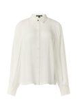 Licht transparante blouse met lange mouwen met manchetten en een knoopsluiting van het merk Commam in de kleur wit.