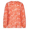 De Cecile blouse van het merk Nukus heeft een all over print en een V hals met kwastjes eraan en lange mouwen in de kleur zand/oranje.